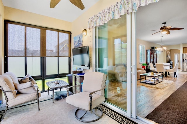 sunroom / solarium featuring a chandelier