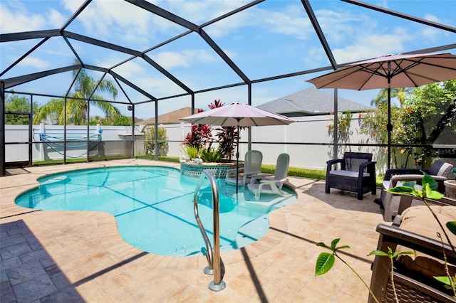 view of pool featuring a patio, a fenced in pool, a fenced backyard, outdoor lounge area, and glass enclosure