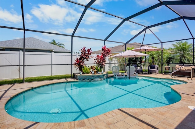 view of swimming pool with a patio, fence, glass enclosure, and a fenced in pool