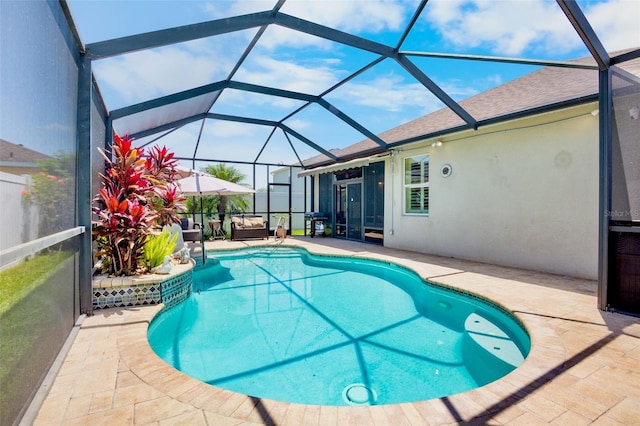 outdoor pool with glass enclosure and a patio area