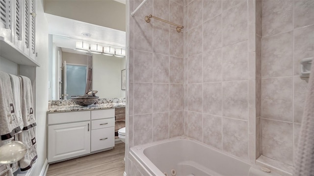 4861 Waterbridge Down, Sarasota, FL 34235 - full bathroom with vanity, wood finished floors, and a combined bath / shower with jetted tub
