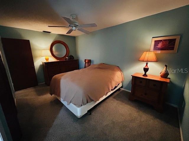 bedroom featuring baseboards, ceiling fan, and carpet flooring