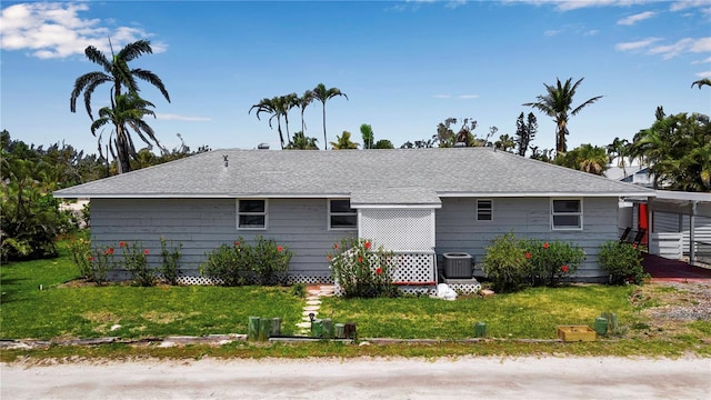 7030 Lois Ave, Longboat Key, FL 34228 - back of property featuring a yard and central AC