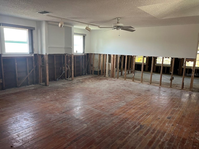 7030 Lois Ave, Longboat Key, FL 34228 - spare room featuring a textured ceiling, wood-type flooring, and visible vents