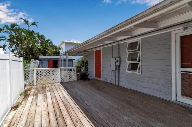 7030 Lois Ave, Longboat Key, FL 34228 - wooden deck with an outdoor structure, fence, and a storage unit