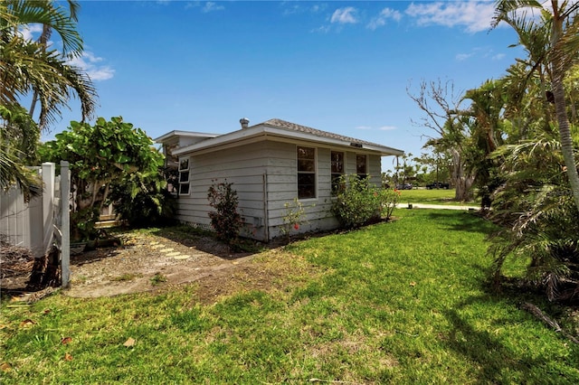 7030 Lois Ave, Longboat Key, FL 34228 - view of property exterior featuring fence and a lawn