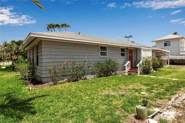 7030 Lois Ave, Longboat Key, FL 34228 - back of property with a lawn and entry steps