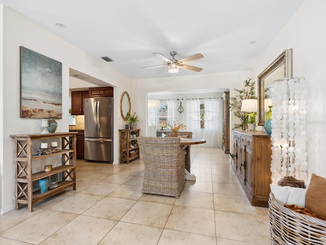 interior space with light tile patterned floors, visible vents, and ceiling fan