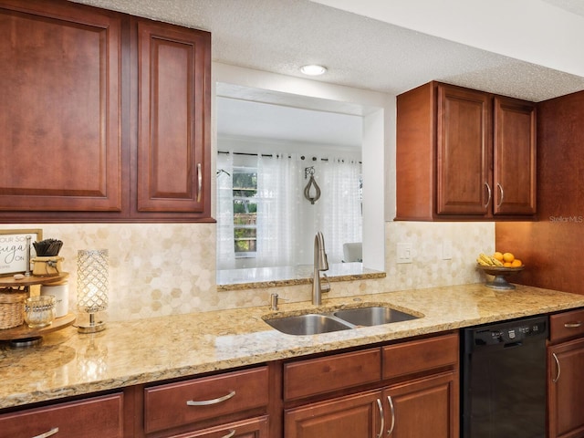 kitchen featuring light stone countertops, tasteful backsplash, dishwasher, and a sink