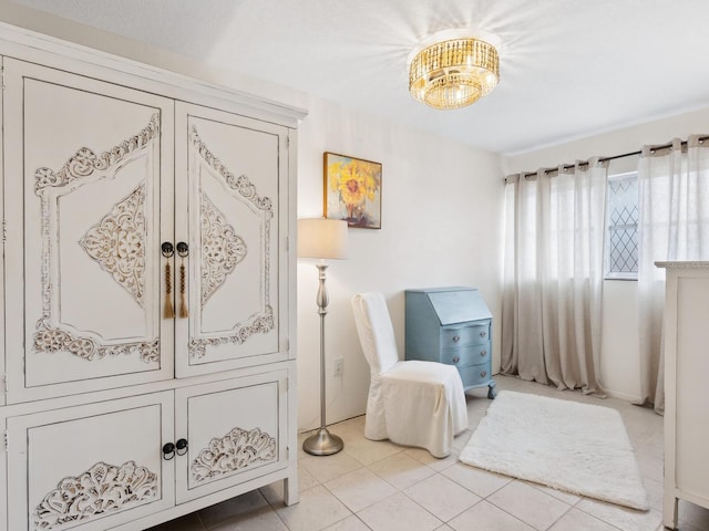 living area featuring an inviting chandelier and light tile patterned flooring