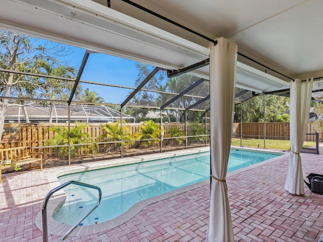view of swimming pool with a fenced in pool, a patio area, glass enclosure, and a fenced backyard