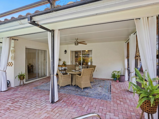 view of patio featuring outdoor dining area and a ceiling fan