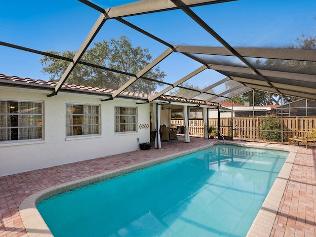 view of swimming pool with fence, a lanai, a patio, and a fenced in pool