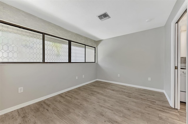 unfurnished bedroom with baseboards, light wood-type flooring, and visible vents