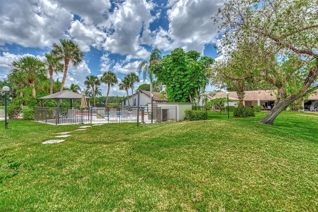 view of yard with fence and a gazebo
