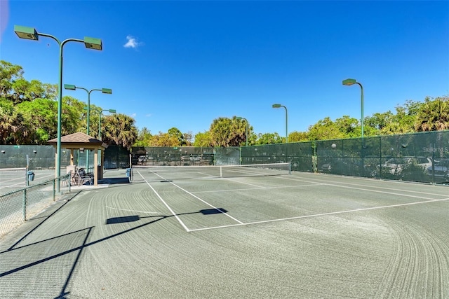 view of tennis court with fence