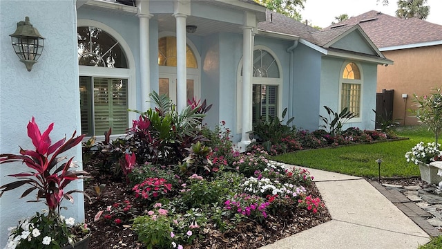 1600 Twin Oaks Cir, Oviedo, FL 32765 - entrance to property featuring covered porch, roof with shingles, and stucco siding