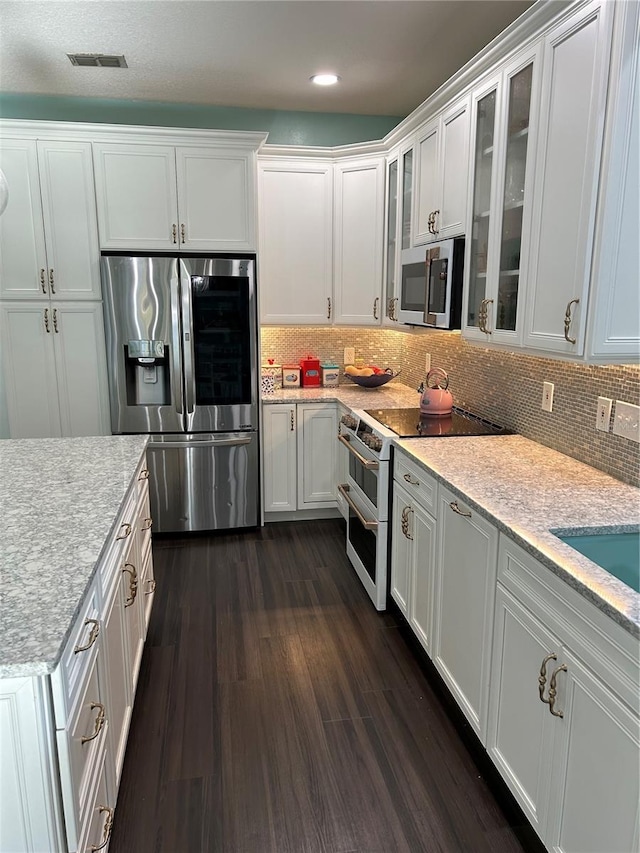 1600 Twin Oaks Cir, Oviedo, FL 32765 - kitchen with white cabinets, glass insert cabinets, visible vents, and stainless steel appliances