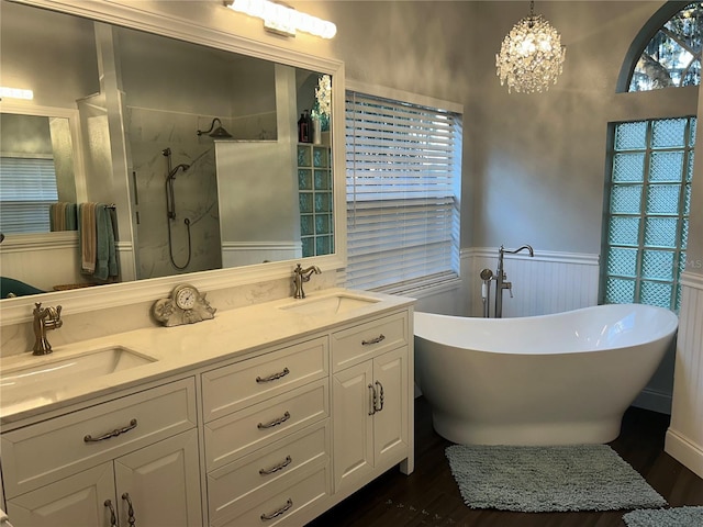 1600 Twin Oaks Cir, Oviedo, FL 32765 - full bathroom featuring wood finished floors, walk in shower, a wainscoted wall, and a sink