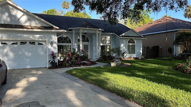 1600 Twin Oaks Cir, Oviedo, FL 32765 - single story home with a garage, concrete driveway, a front yard, and stucco siding