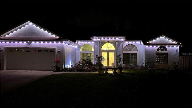 1600 Twin Oaks Cir, Oviedo, FL 32765 - view of front of home with an attached garage, stucco siding, and driveway