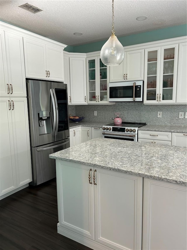 1600 Twin Oaks Cir, Oviedo, FL 32765 - kitchen featuring white cabinets, dark wood-style flooring, visible vents, and stainless steel appliances