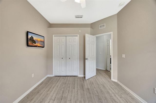 14315 Tree Swallow Way, Lakewood Ranch, FL 34202 - unfurnished bedroom featuring light wood-style floors, a closet, baseboards, and ceiling fan