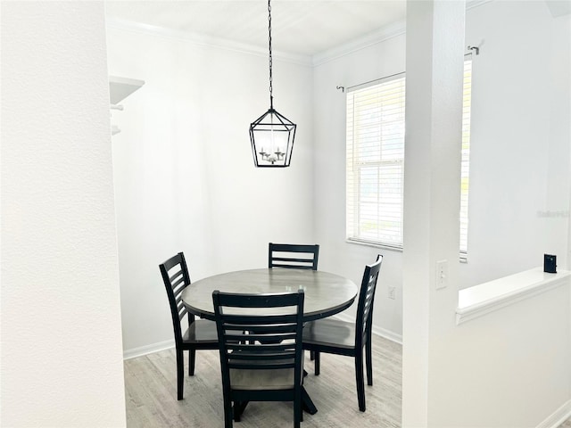 14315 Tree Swallow Way, Lakewood Ranch, FL 34202 - dining space featuring baseboards, wood finished floors, crown molding, healthy amount of natural light, and a chandelier