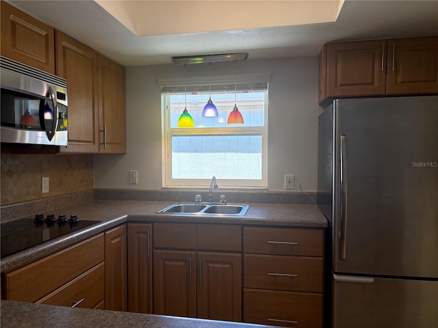 5057 Live Oak Cir Unit 86, Bradenton, FL 34207 - kitchen with appliances with stainless steel finishes, a sink, dark countertops, and brown cabinetry