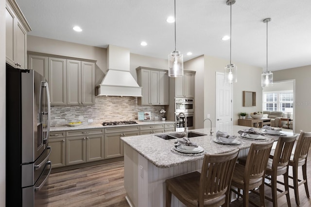 569 Mast Dr, Bradenton, FL 34208 - kitchen featuring appliances with stainless steel finishes, gray cabinetry, custom exhaust hood, dark wood-style floors, and recessed lighting