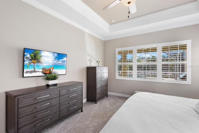 569 Mast Dr, Bradenton, FL 34208 - bedroom with light colored carpet, baseboards, ornamental molding, a tray ceiling, and a ceiling fan