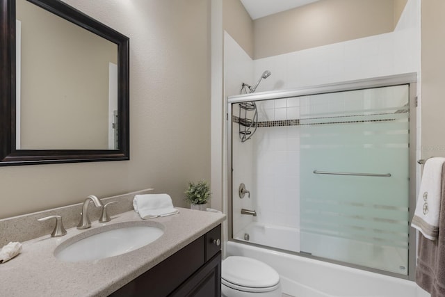 569 Mast Dr, Bradenton, FL 34208 - bathroom featuring vanity, toilet, and shower / bath combination with glass door