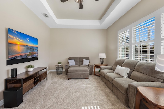 569 Mast Dr, Bradenton, FL 34208 - living room with ceiling fan, light carpet, a raised ceiling, and baseboards