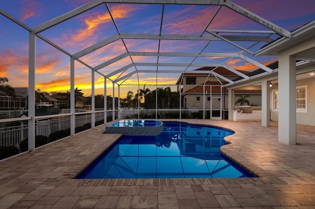 569 Mast Dr, Bradenton, FL 34208 - pool at dusk featuring a patio, a pool with connected hot tub, and a lanai