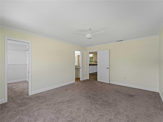 3405 10th St W, Palmetto, FL 34221 - interior space featuring a textured ceiling, a spacious closet, crown molding, and carpet floors
