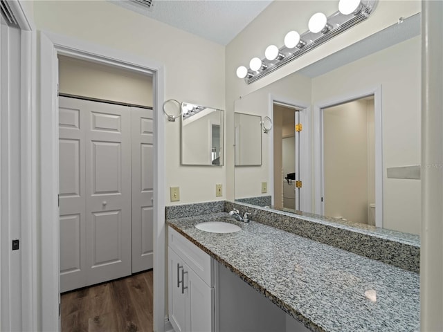 3405 10th St W, Palmetto, FL 34221 - bathroom with toilet, vanity, and wood finished floors