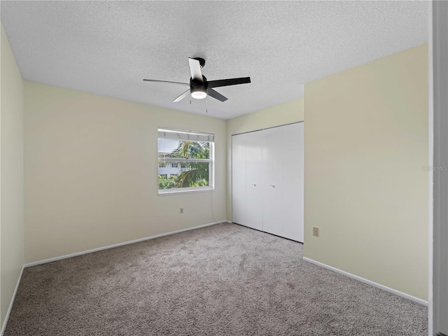 3405 10th St W, Palmetto, FL 34221 - unfurnished bedroom with a textured ceiling, a closet, carpet, and baseboards