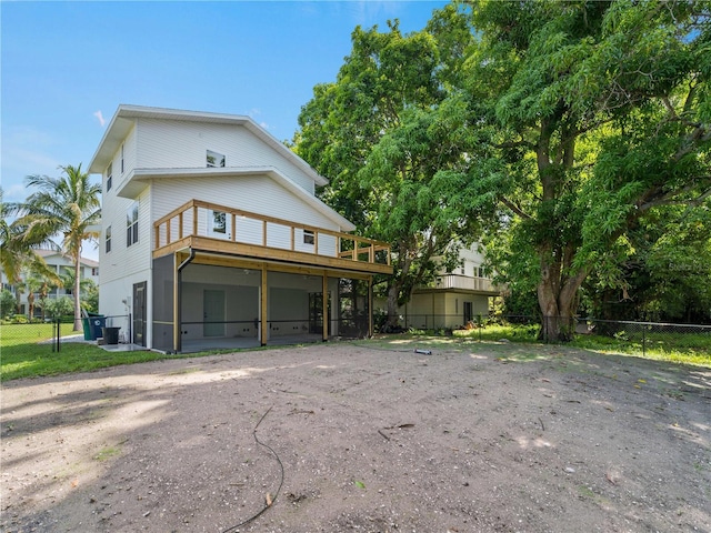 3405 10th St W, Palmetto, FL 34221 - view of front of house featuring fence, dirt driveway, and a sunroom