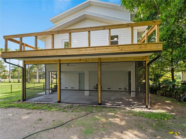 3405 10th St W, Palmetto, FL 34221 - back of house with fence, a patio, and a sunroom