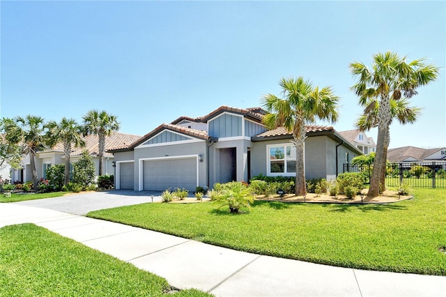 view of front of home featuring fence, an attached garage, a tile roof, stucco siding, and driveway