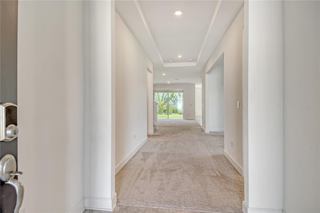 hall featuring baseboards, light carpet, and recessed lighting