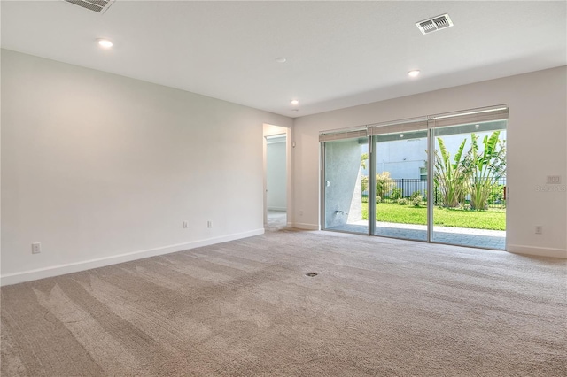 empty room featuring baseboards, light carpet, recessed lighting, and visible vents