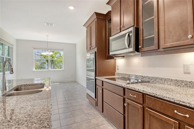 kitchen with a sink, appliances with stainless steel finishes, a wealth of natural light, and visible vents