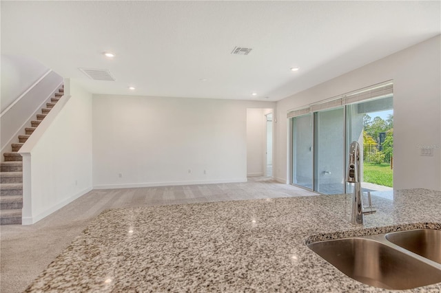 interior space featuring stairs, recessed lighting, visible vents, and a sink