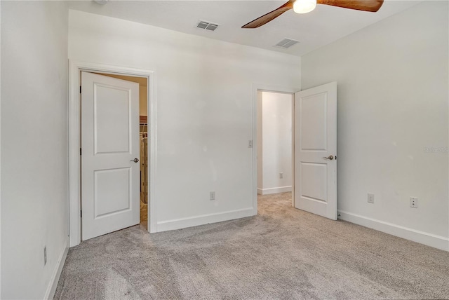 unfurnished bedroom featuring carpet flooring, baseboards, and visible vents