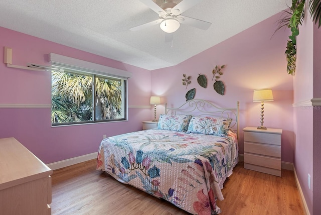 5736 Ashton Lake Dr, Sarasota, FL 34231 - bedroom with wood finished floors, baseboards, ceiling fan, and a textured ceiling