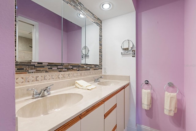 5736 Ashton Lake Dr, Sarasota, FL 34231 - bathroom featuring backsplash, double vanity, and baseboards