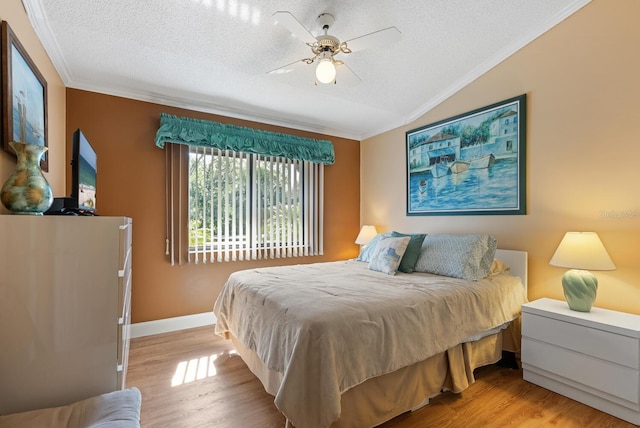 5736 Ashton Lake Dr, Sarasota, FL 34231 - bedroom with ornamental molding, a textured ceiling, light wood-type flooring, vaulted ceiling, and a ceiling fan