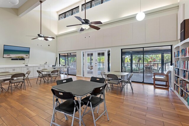 5736 Ashton Lake Dr, Sarasota, FL 34231 - dining room with ceiling fan, a high ceiling, french doors, and light wood finished floors