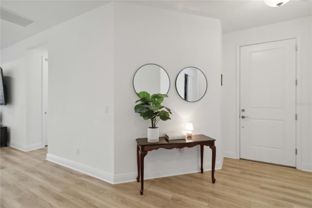 entryway featuring light wood finished floors and baseboards